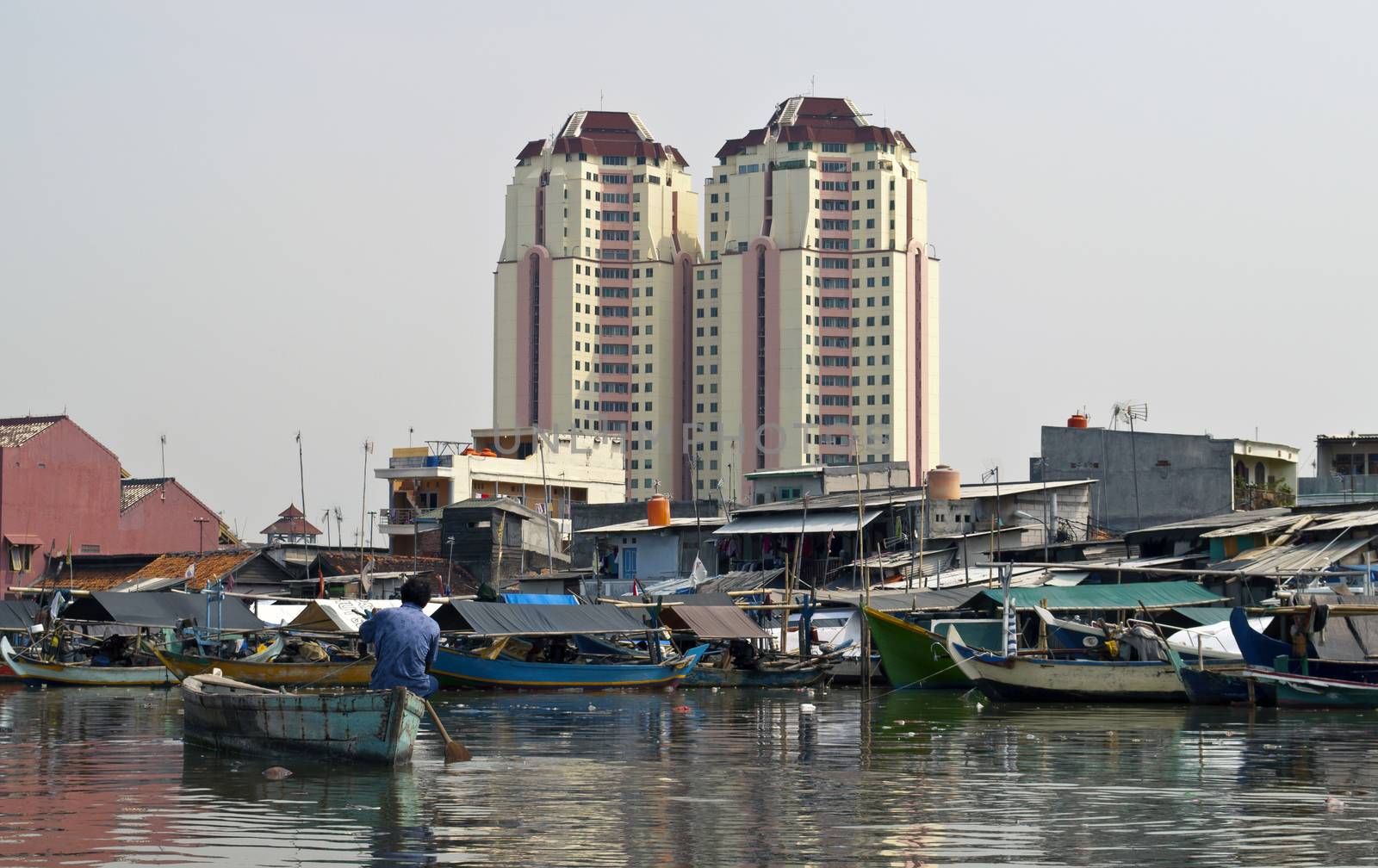 Old canal full of boats in Jakarta harbor, Indonesia