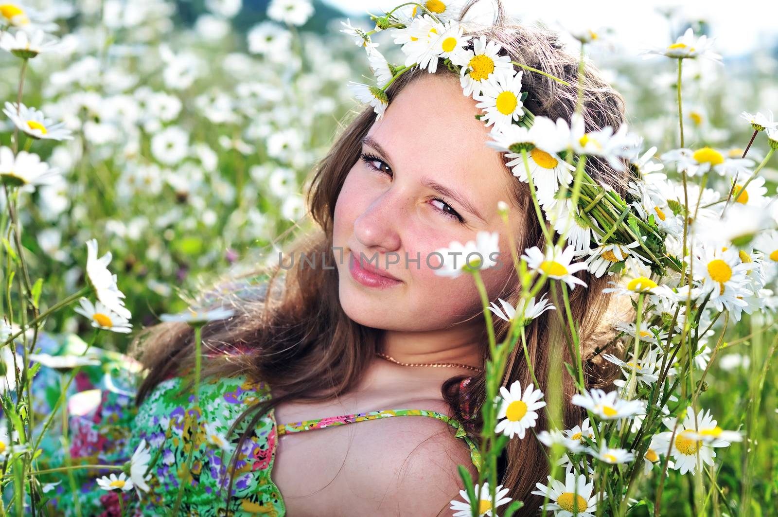 beauty spring teen girl with garland from daisies 