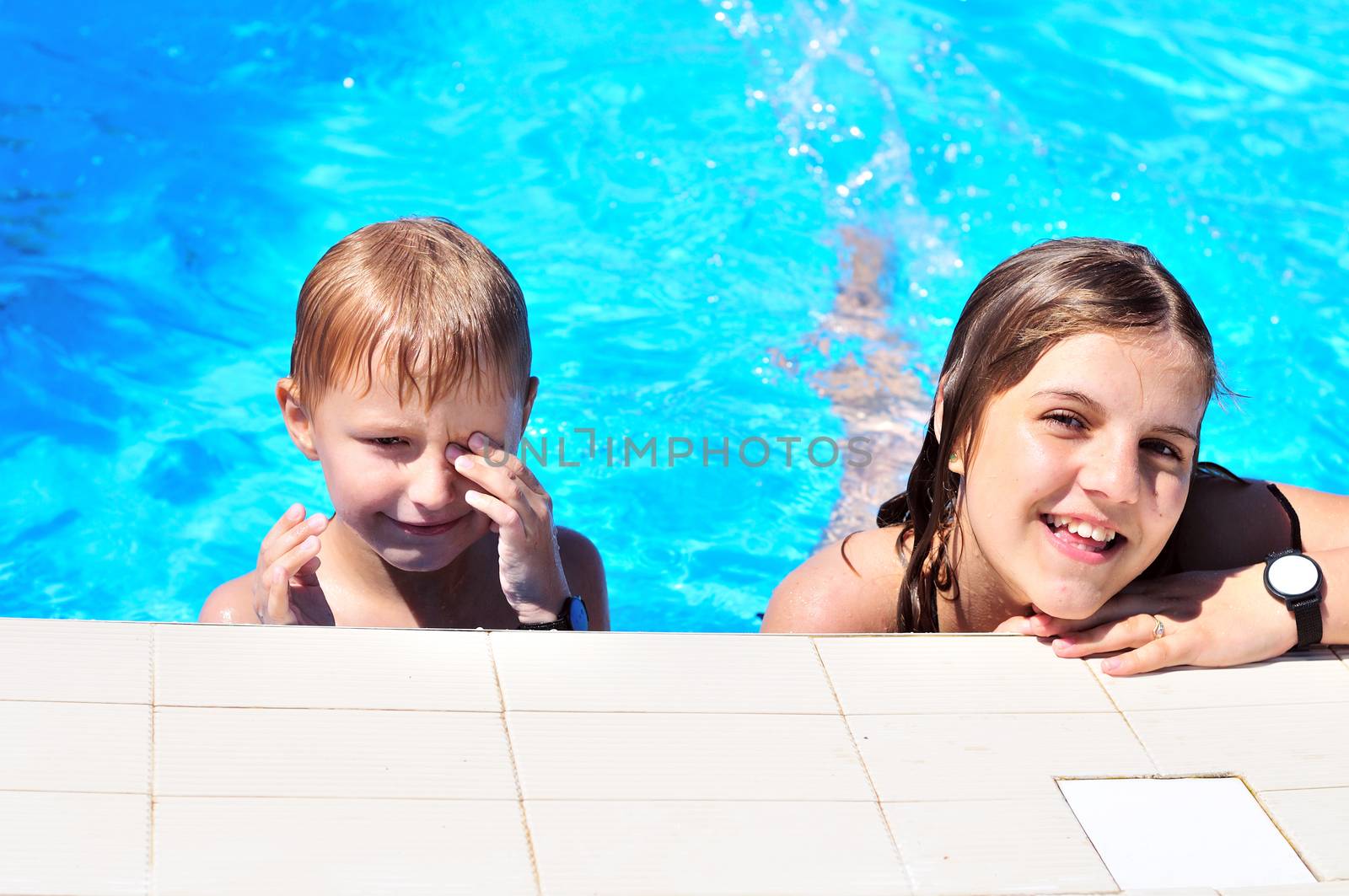 brothe and sister having good time in the pool
