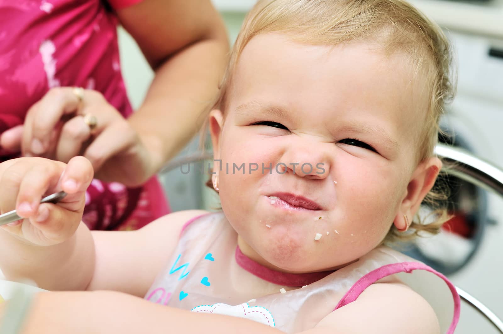 dirty face of funny eating baby girl