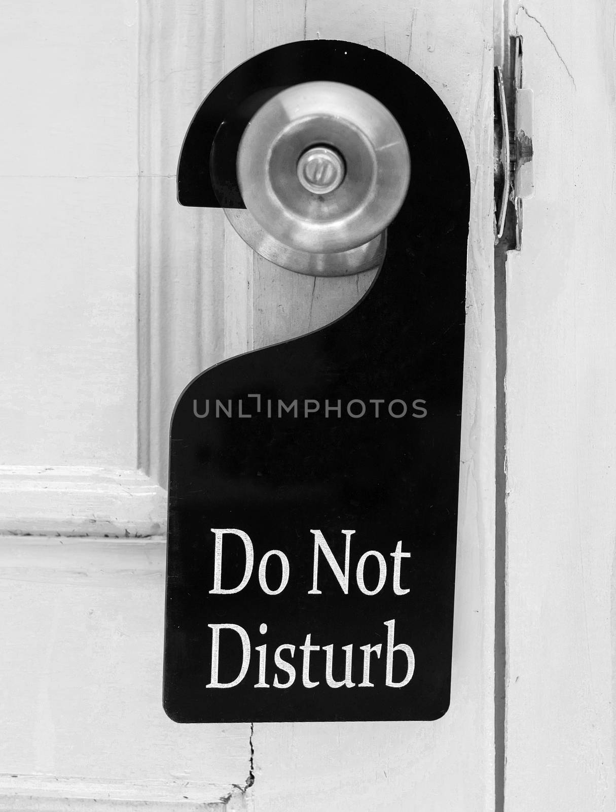 Do not disturb sign hang on door knob and stone wall.