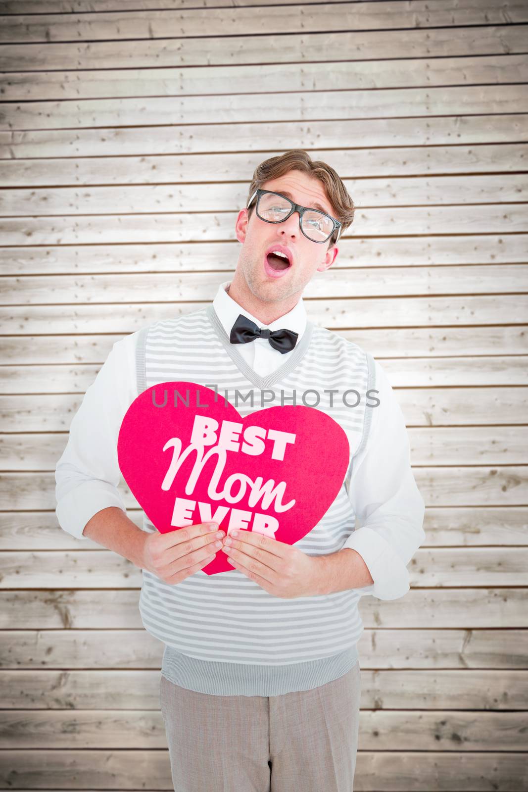 Geeky hipster holding heart card against wooden planks background