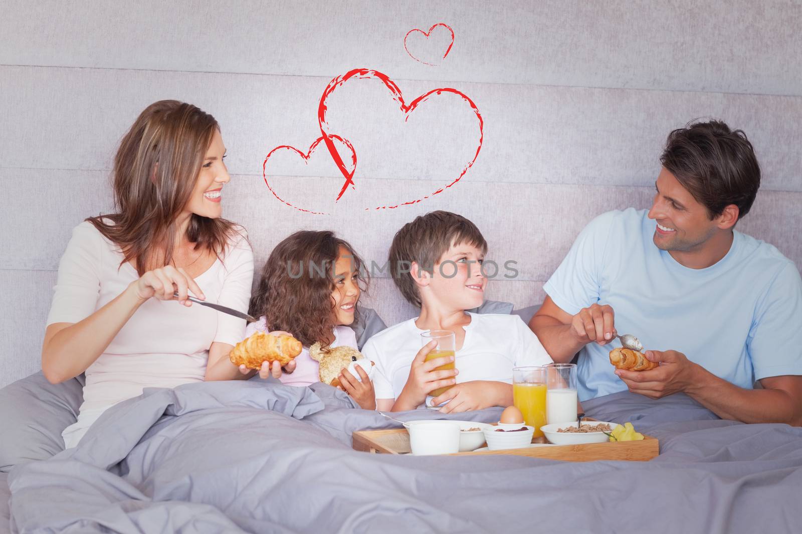 Composite image of family having breakfast in bed by Wavebreakmedia