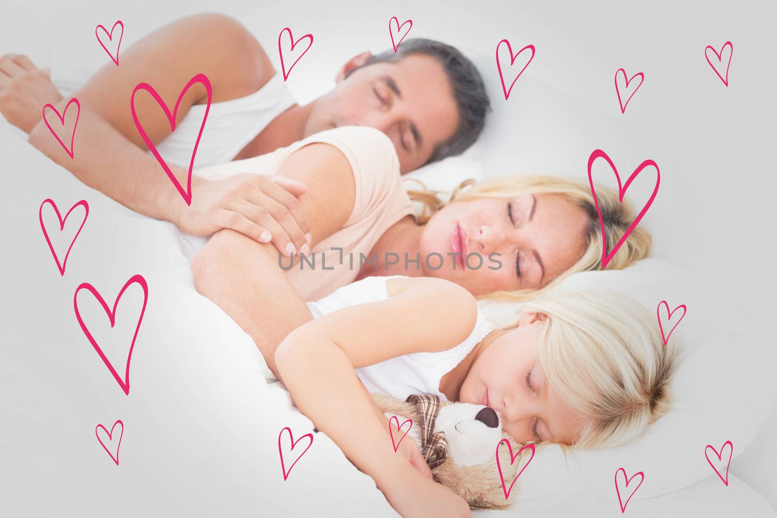 Family sleeping together against red hearts