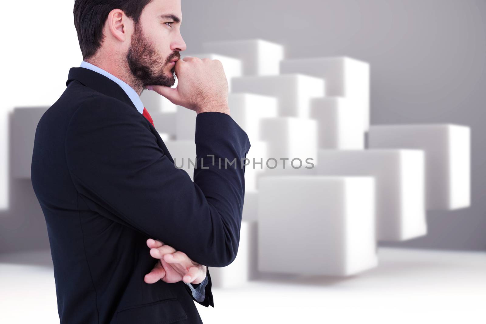 Thinking businessman standing with hand on chin against abstract background