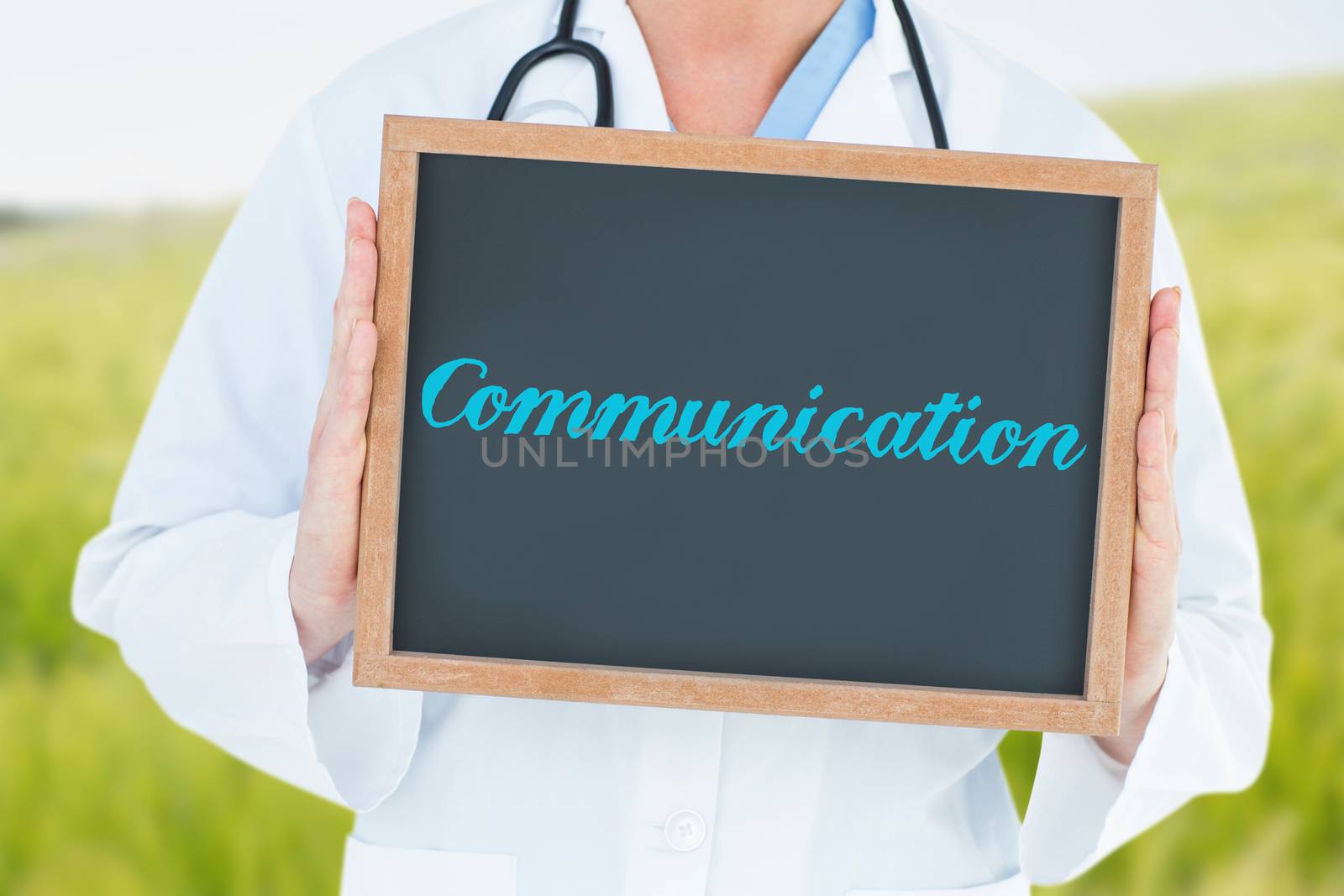 The word communication and doctor showing chalkboard against green meadow