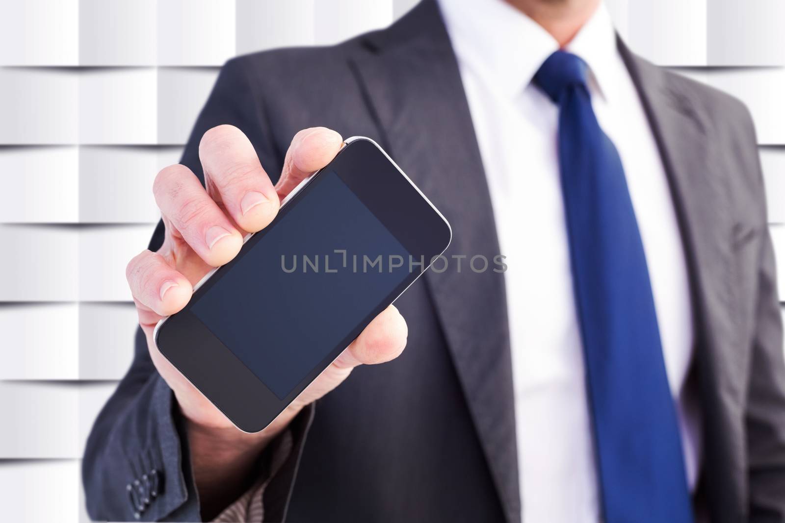 Businessman showing his smartphone screen against abstract background