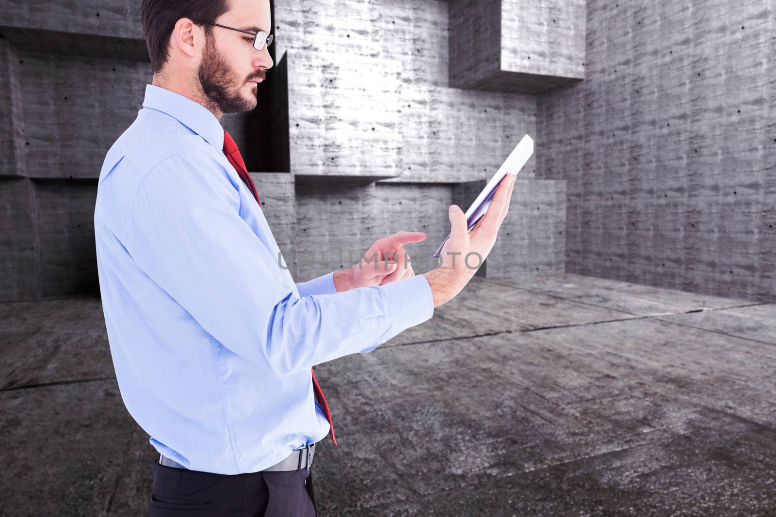 Businessman scrolling on his digital tablet against abstract room