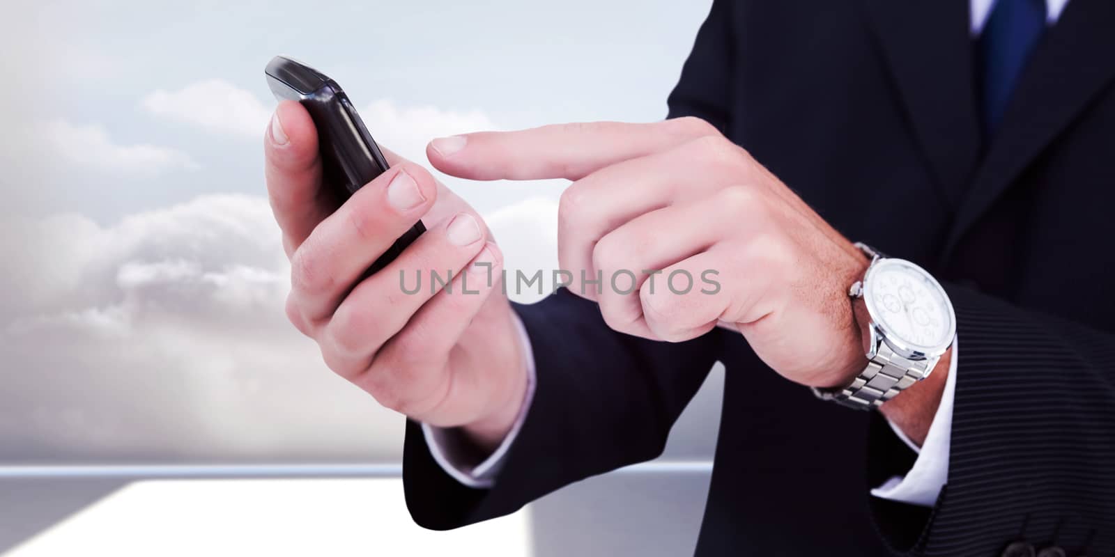 Businessman in glasses using his tablet pc against clouds in a room