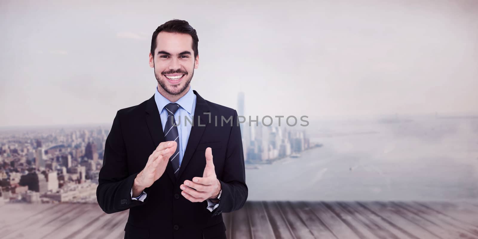 Happy businessman standing and applauding against city scene in a room