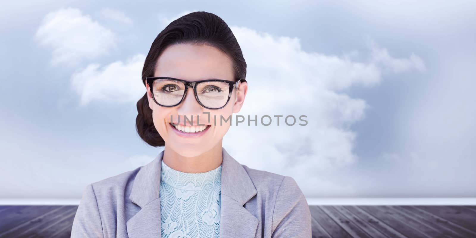 Happy brunette against clouds in a room