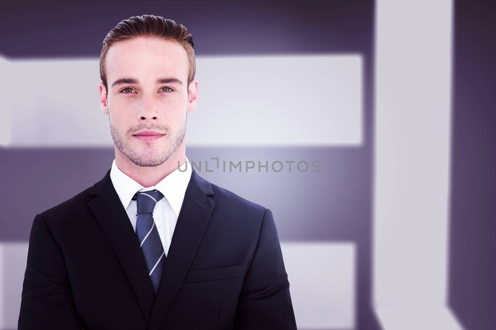 Frowning businessman looking at camera against abstract room