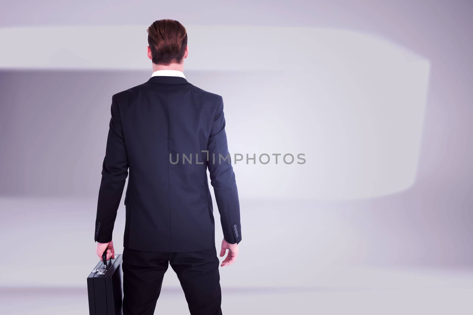 Rear view businessman standing with his briefcase against white abstract room