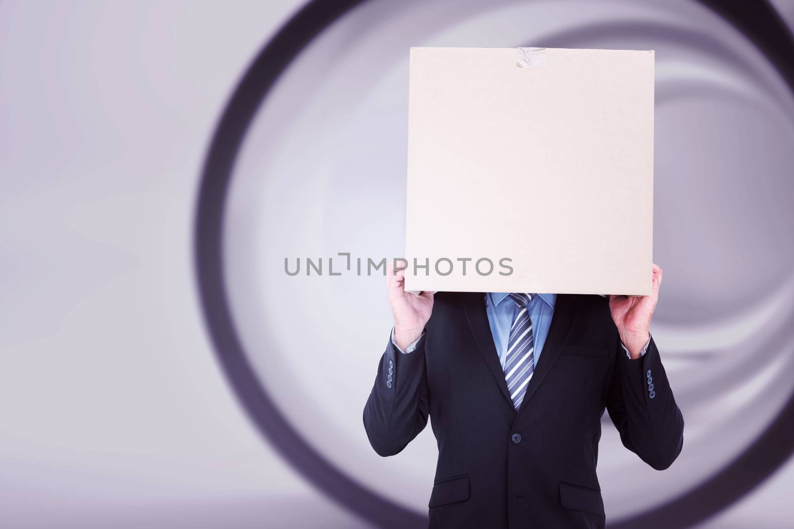 Businessman hiding head with a box against abstract white room