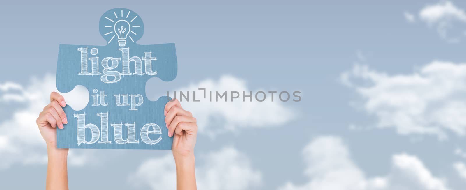 Hands showing jigsaw puzzle against blue sky