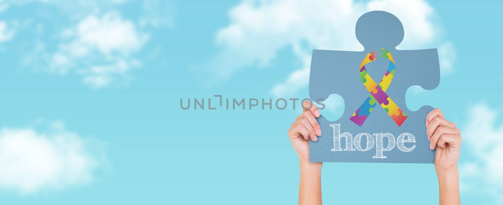 Hands showing jigsaw puzzle against blue sky