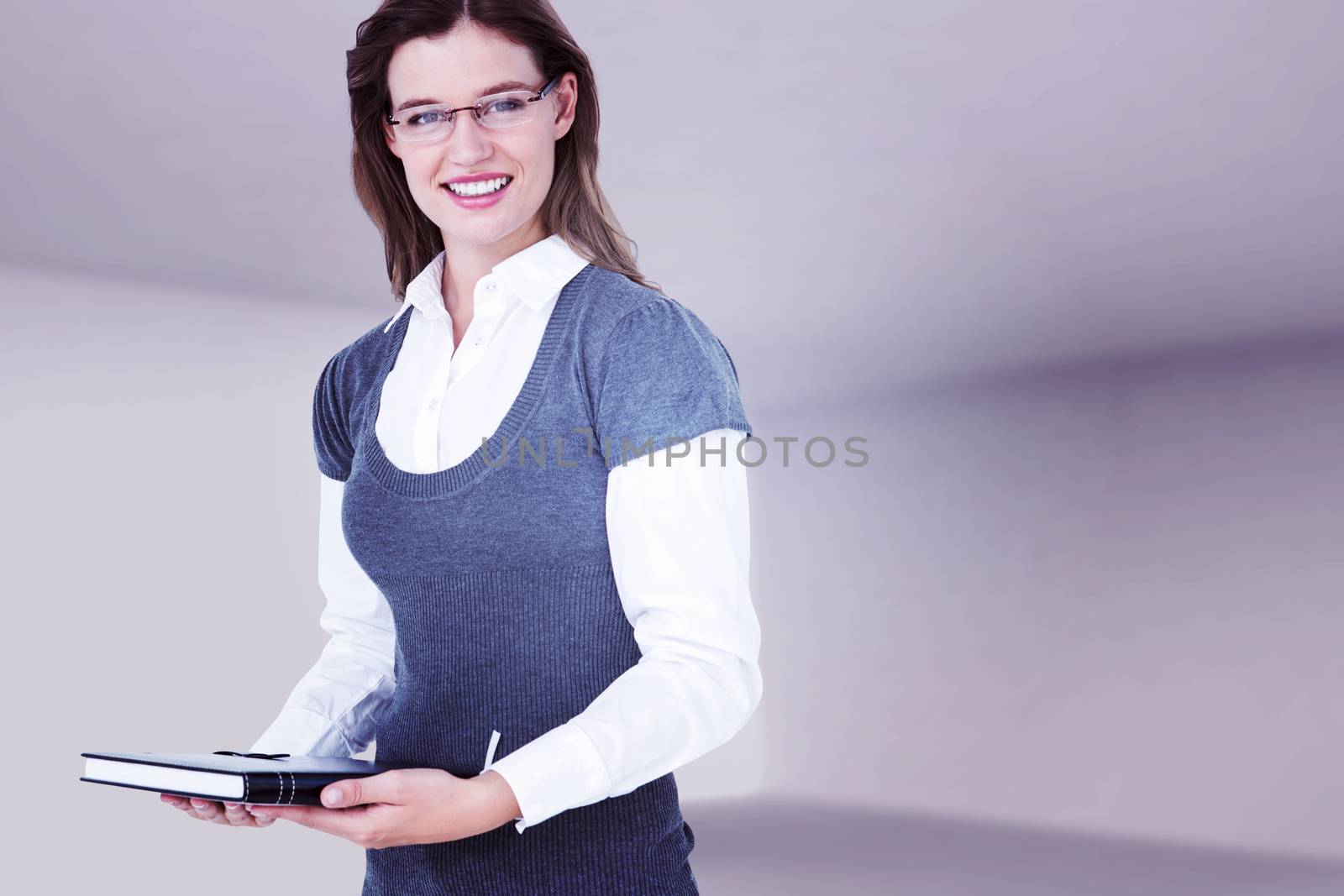 Happy woman holding diary  against abstract room