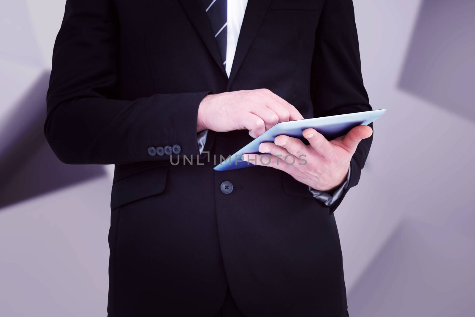 Composite image of businessman touching his tablet pc  by Wavebreakmedia