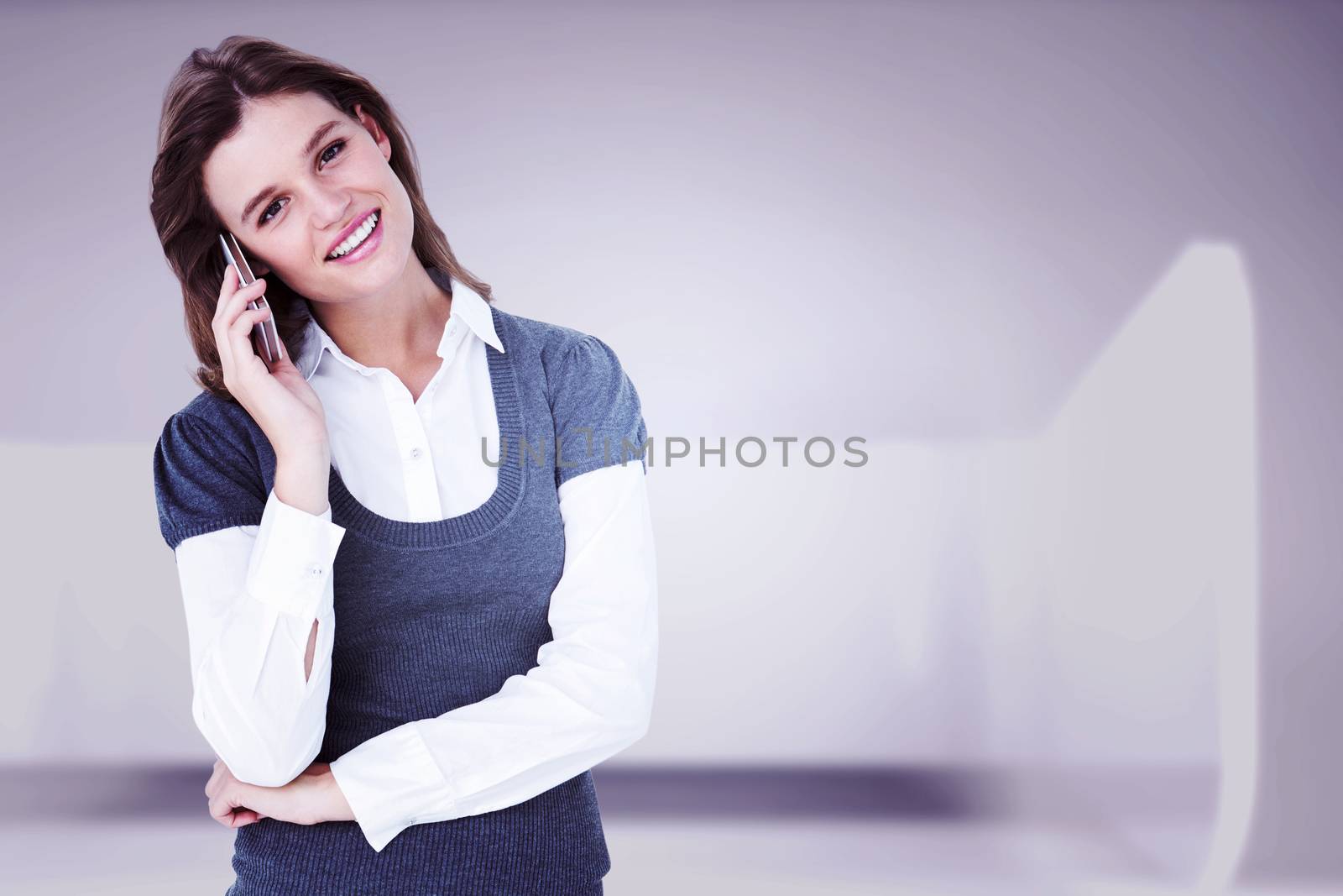 Happy blonde on the phone  against abstract room