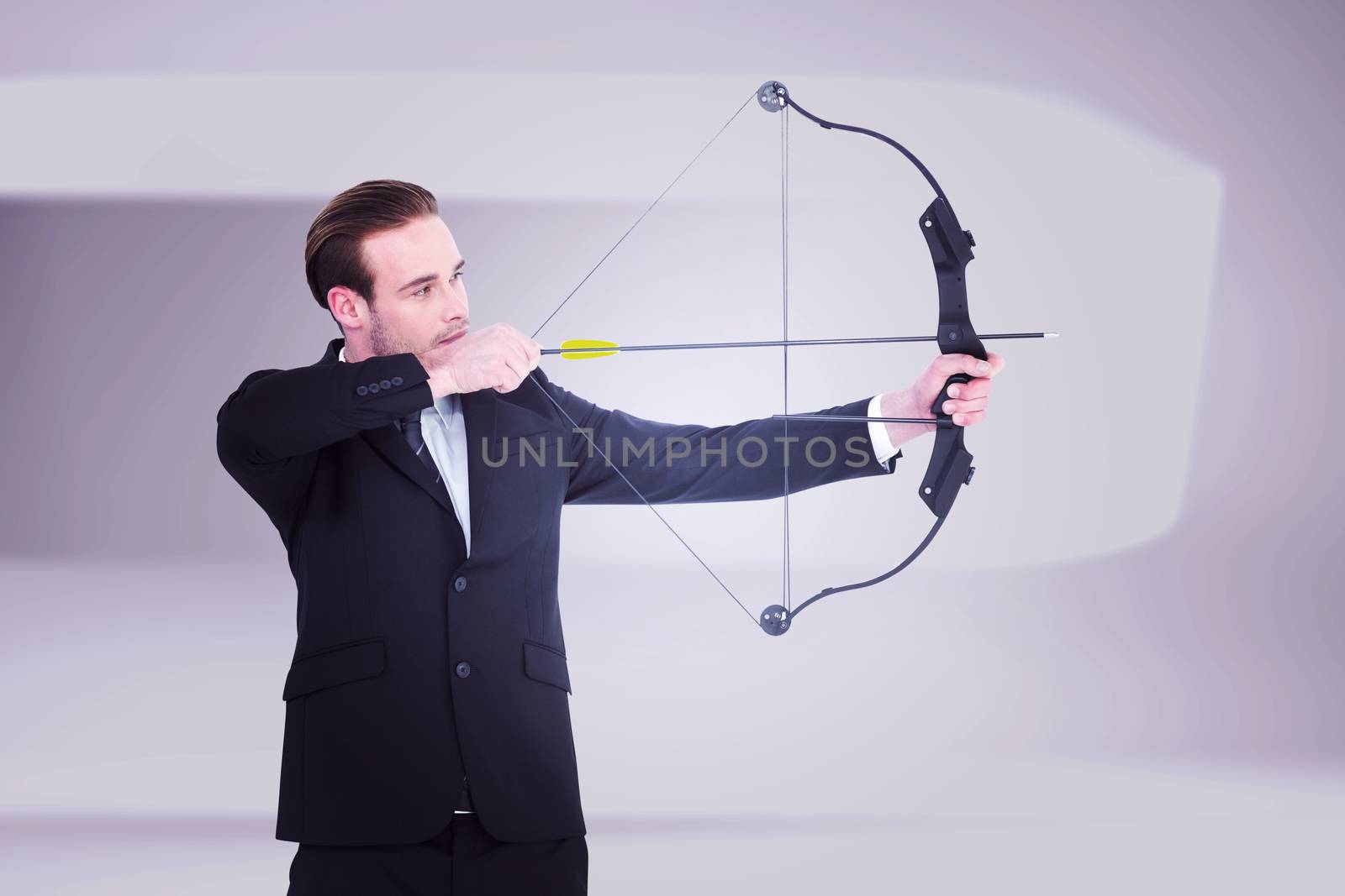 Businessman shooting a bow and arrow against white abstract room