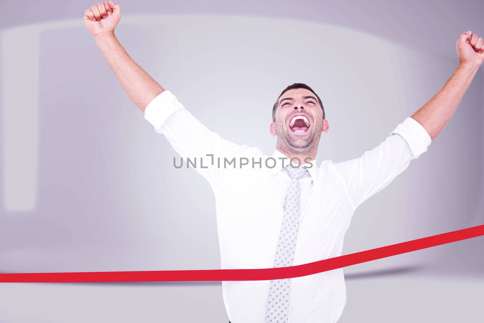 Businessman crossing the finish line against white abstract room