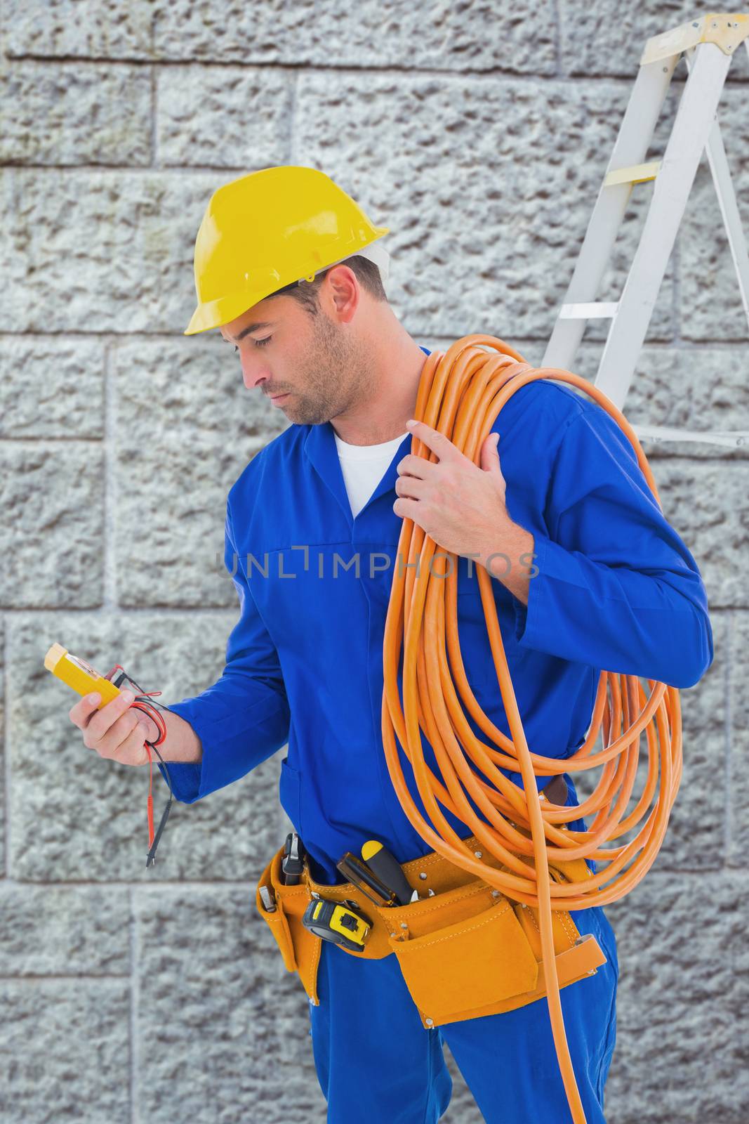 Composite image of electrician reading multimeter in bright office by Wavebreakmedia