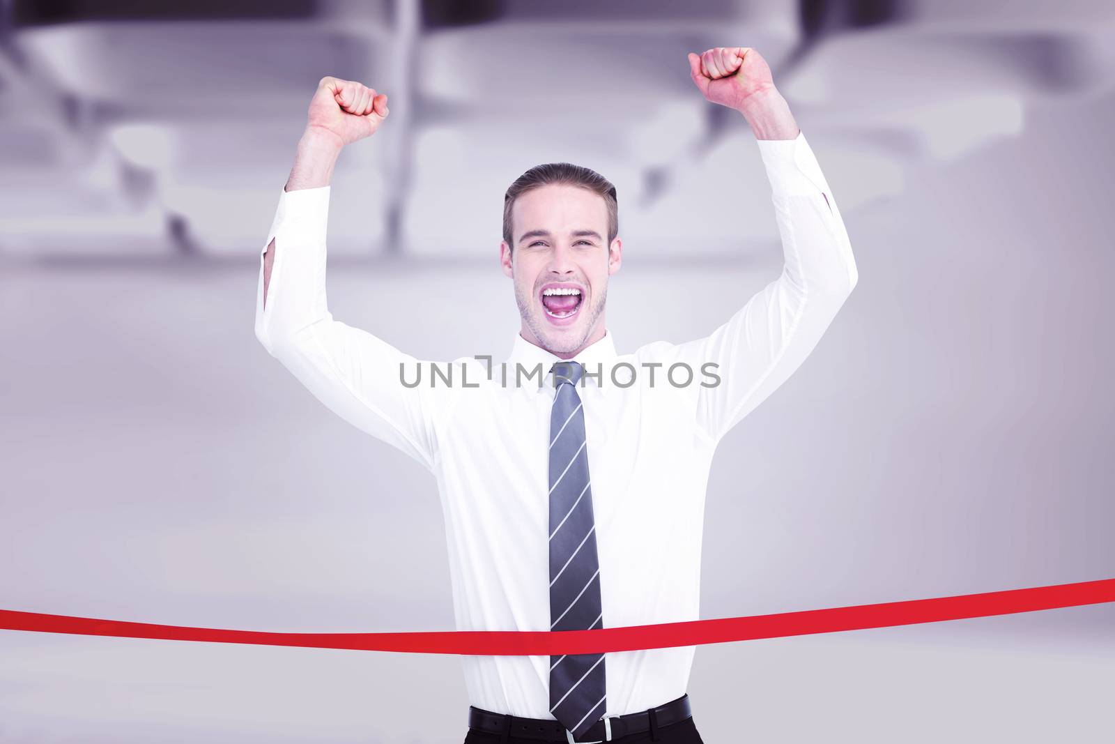 Businessman crossing the finish line and cheering against white abstract room