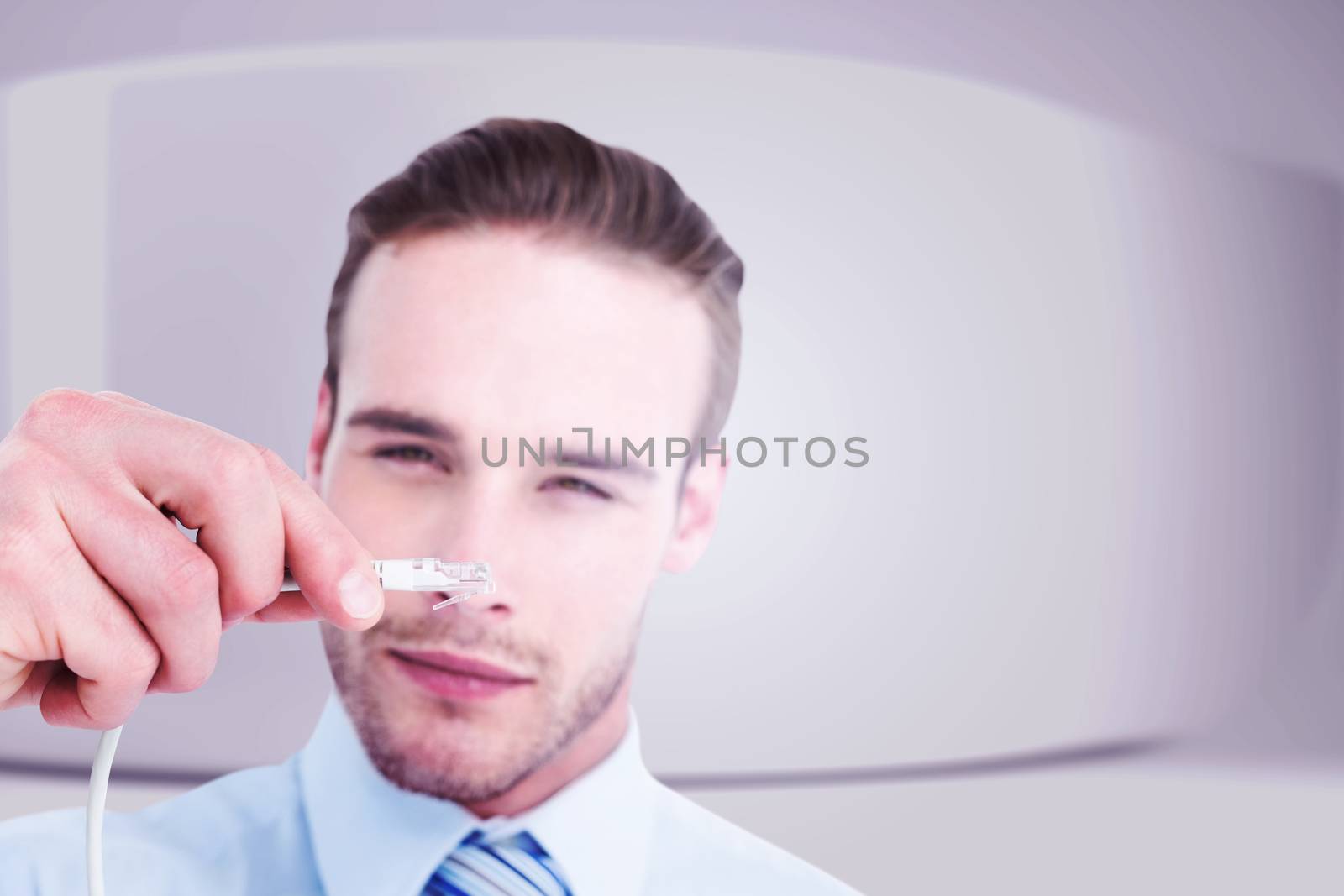 Composite image of concentrated businessman holding a cable by Wavebreakmedia