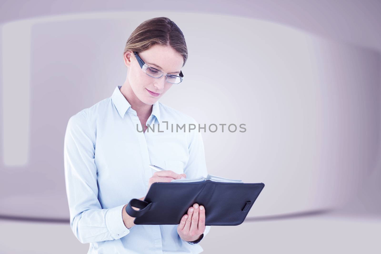 Composite image of businesswoman writing in her diary  by Wavebreakmedia