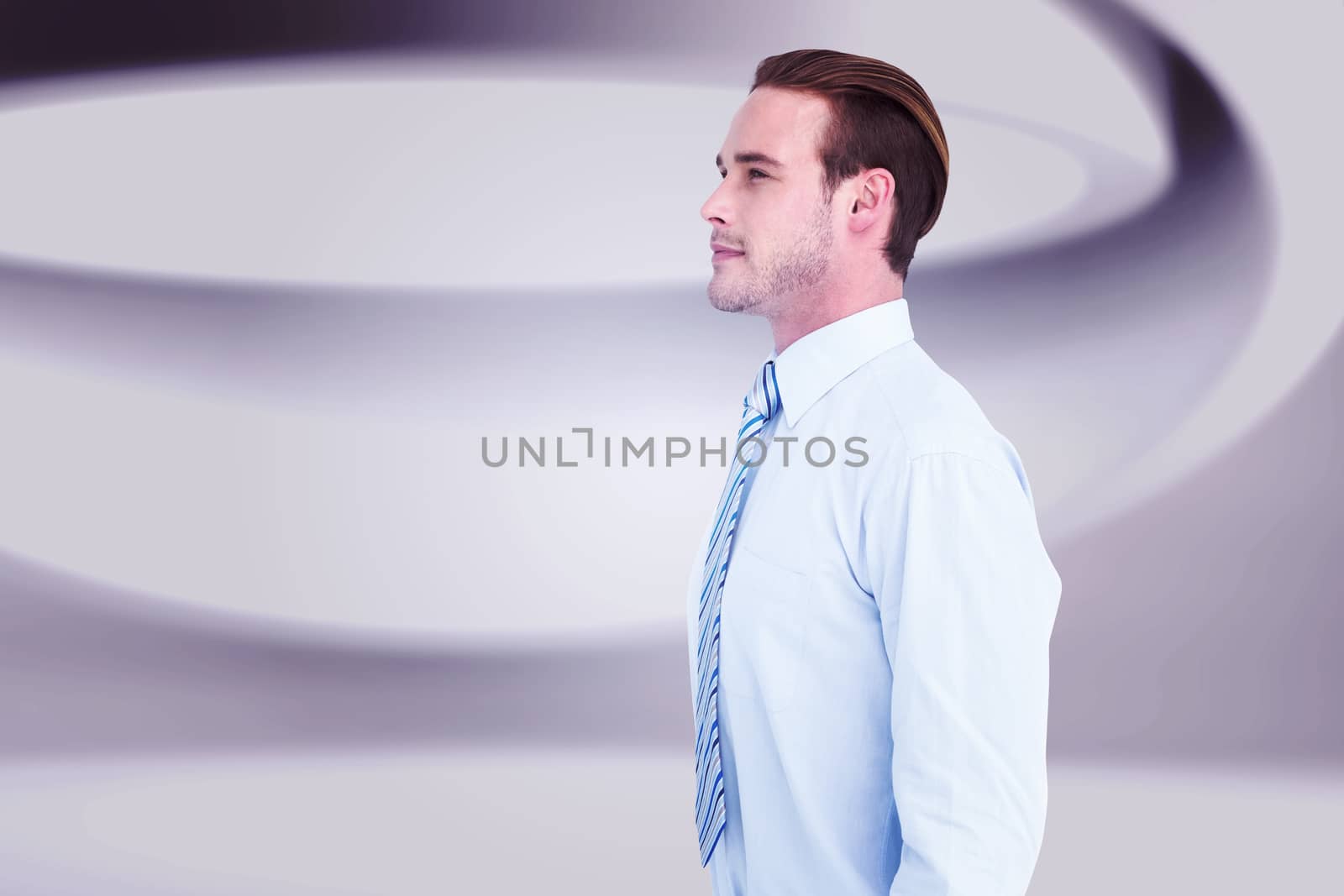 Cheerful businessman posing with hands in pockets against white abstract room