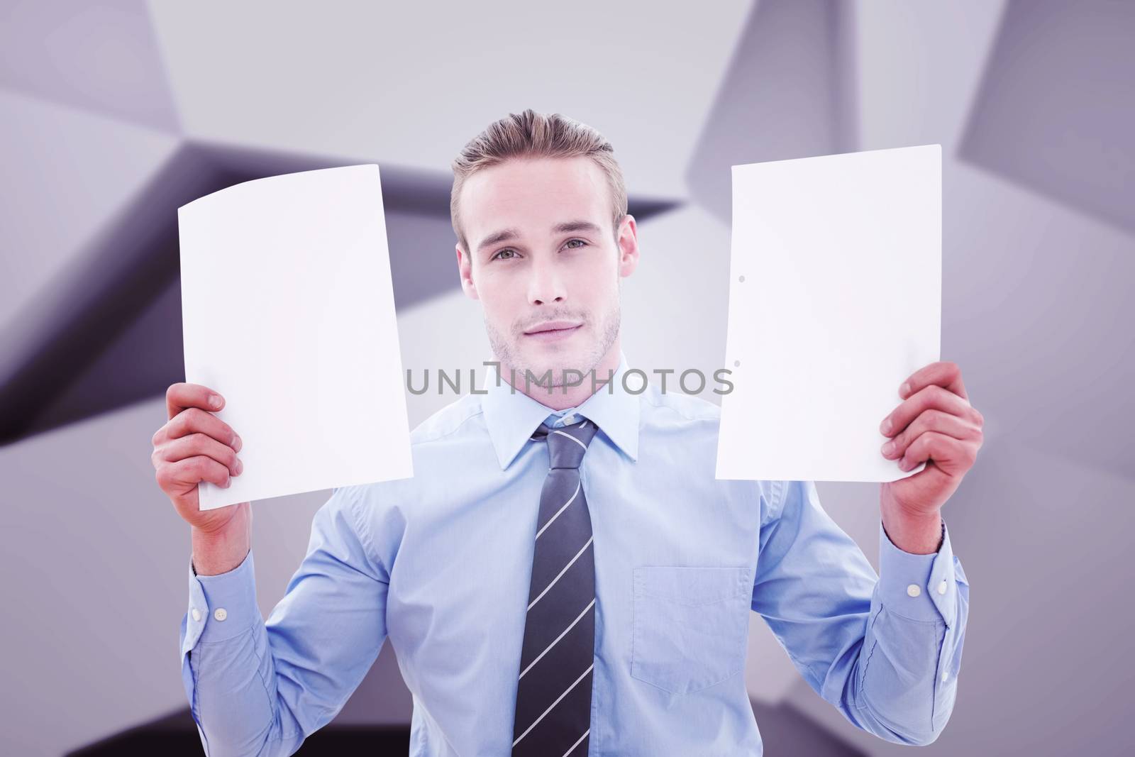 Businessman holding pages against abstract grey room