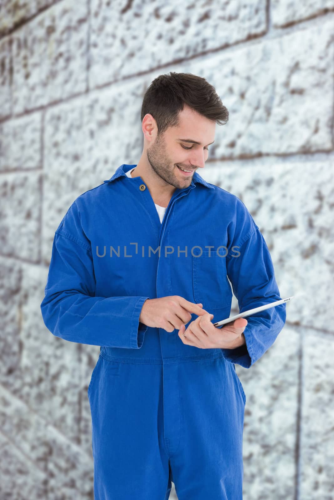 Composite image of male mechanic using digital tablet by Wavebreakmedia
