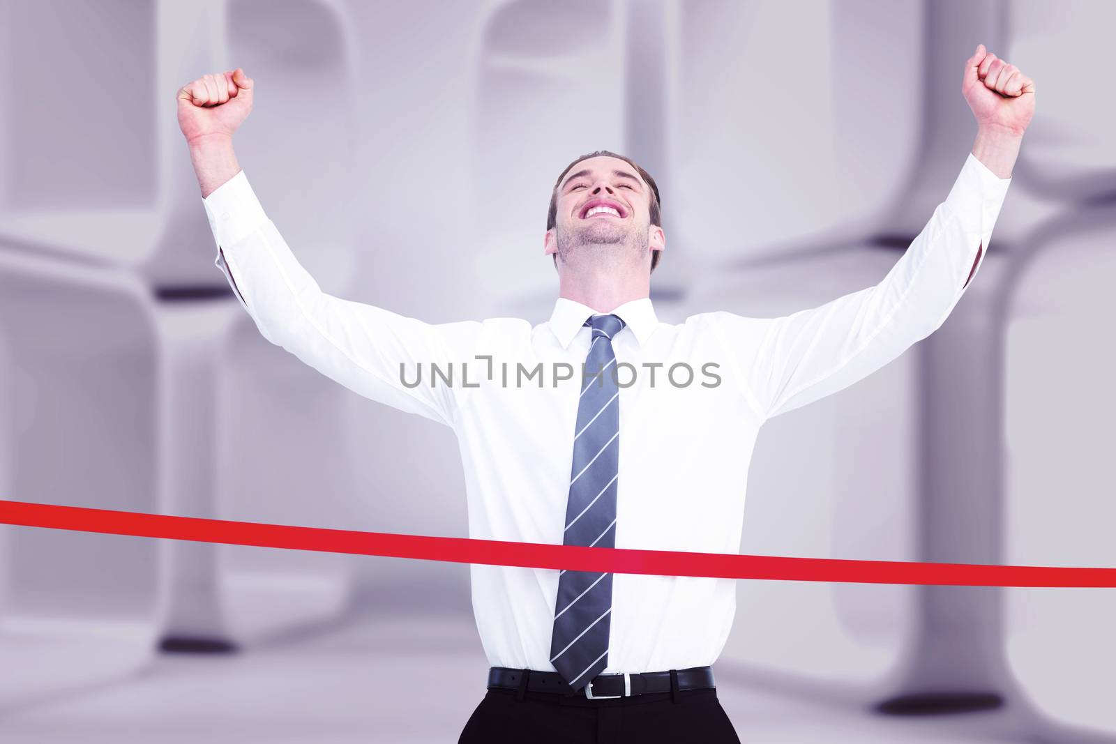 Composite image of happy businessman crossing the finish line by Wavebreakmedia