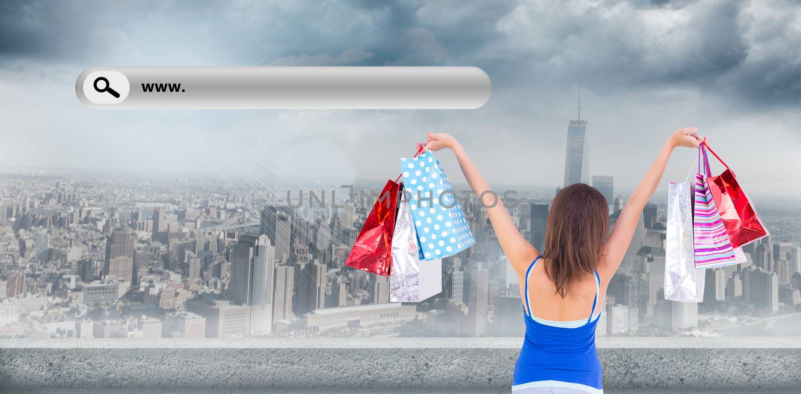 Rear view of a brunette woman raising shopping bags against large city