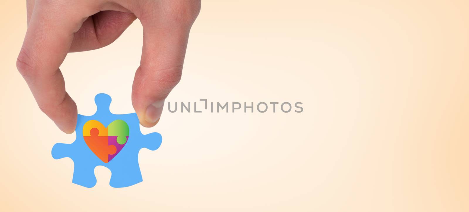 Hand holding jigsaw piece against orange vignette