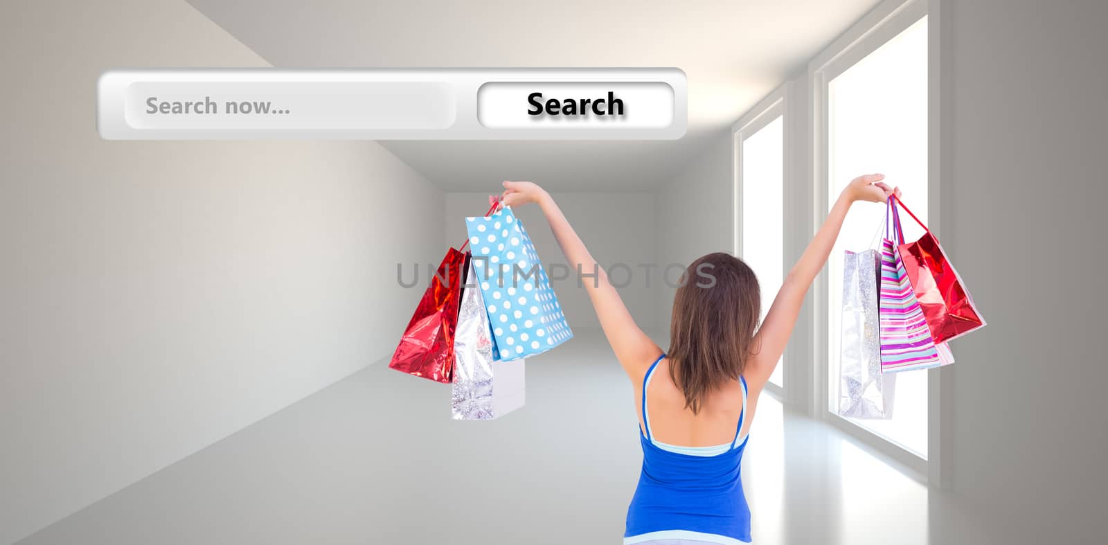 Rear view of a brunette woman raising shopping bags against bright hall with windows