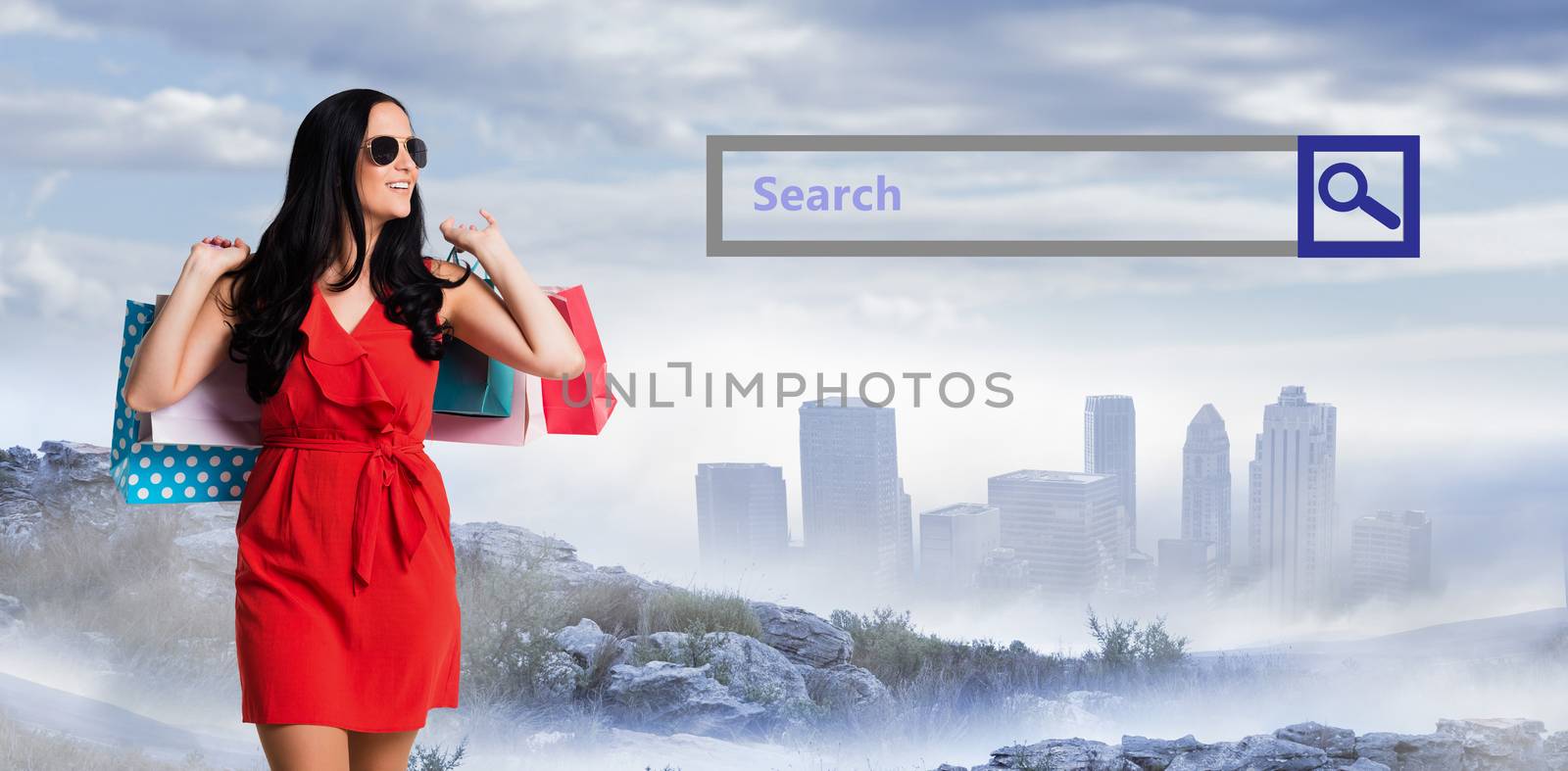 Woman standing with shopping bags against city on the horizon