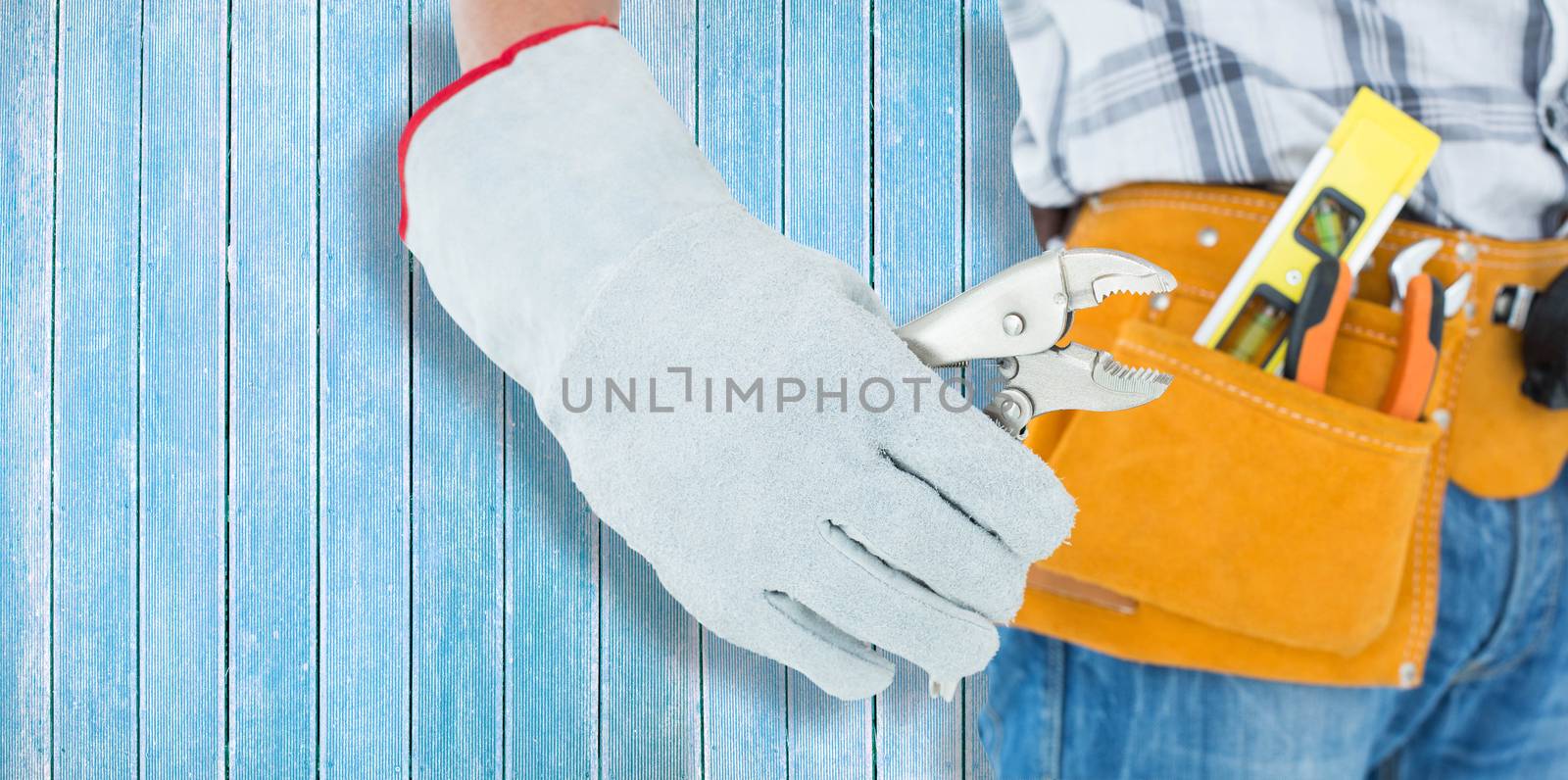 Technician using pliers over white background against wooden planks