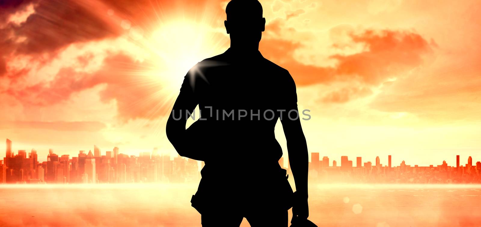 Handyman against sun shining over city