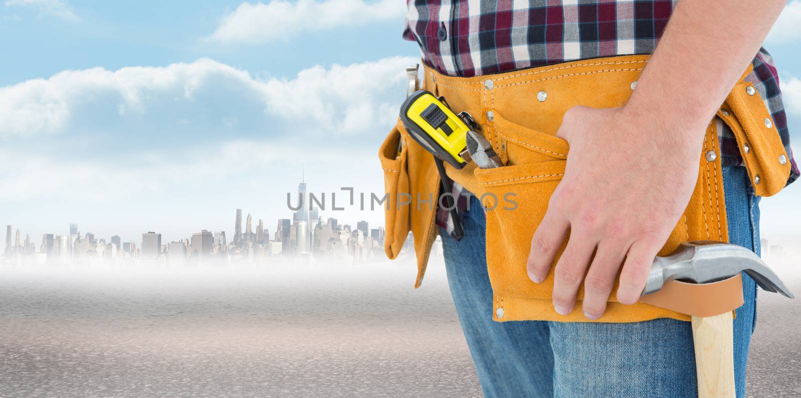Close-up of male repairman wearing tool belt against city on the horizon
