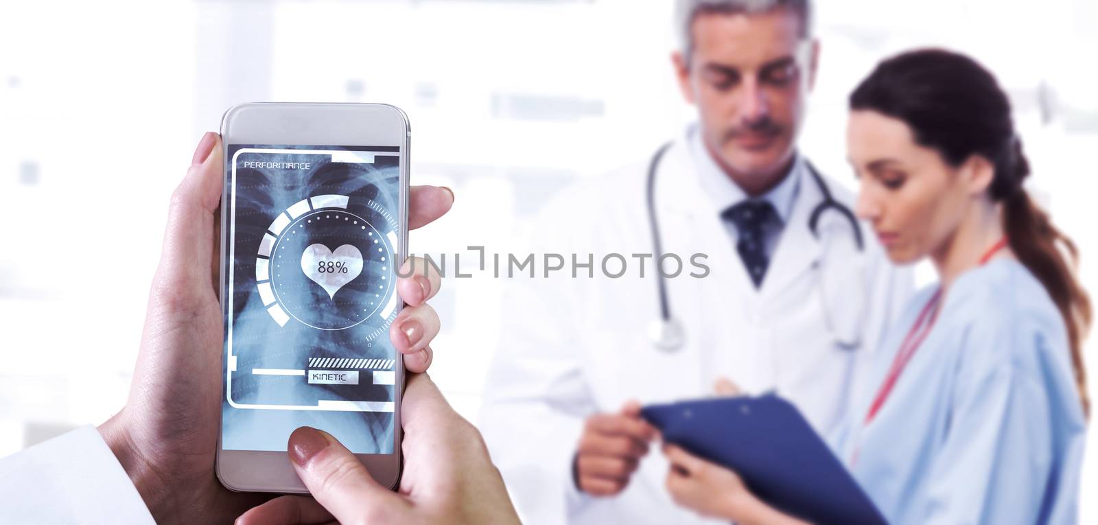 Hand holding smartphone against nurse and doctor looking a file 