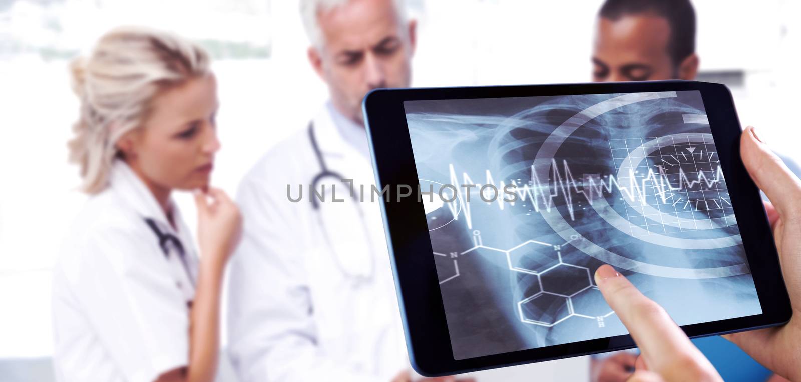 Man using tablet pc against three doctors using a tablet