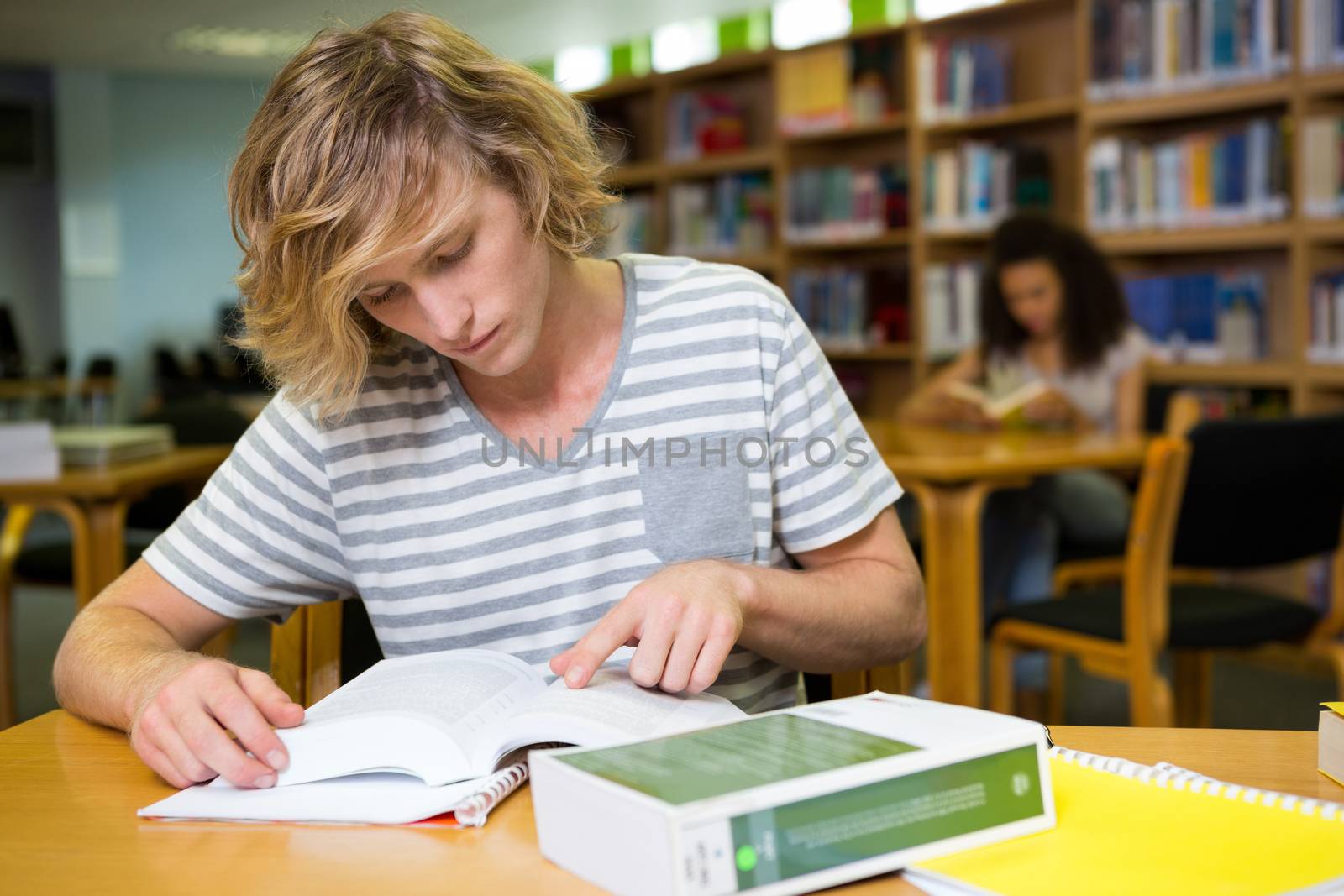 Student studying in the library  by Wavebreakmedia