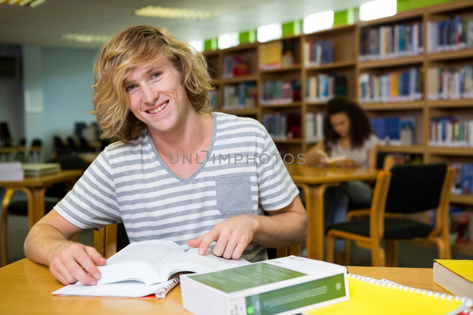 Student studying in the library  by Wavebreakmedia