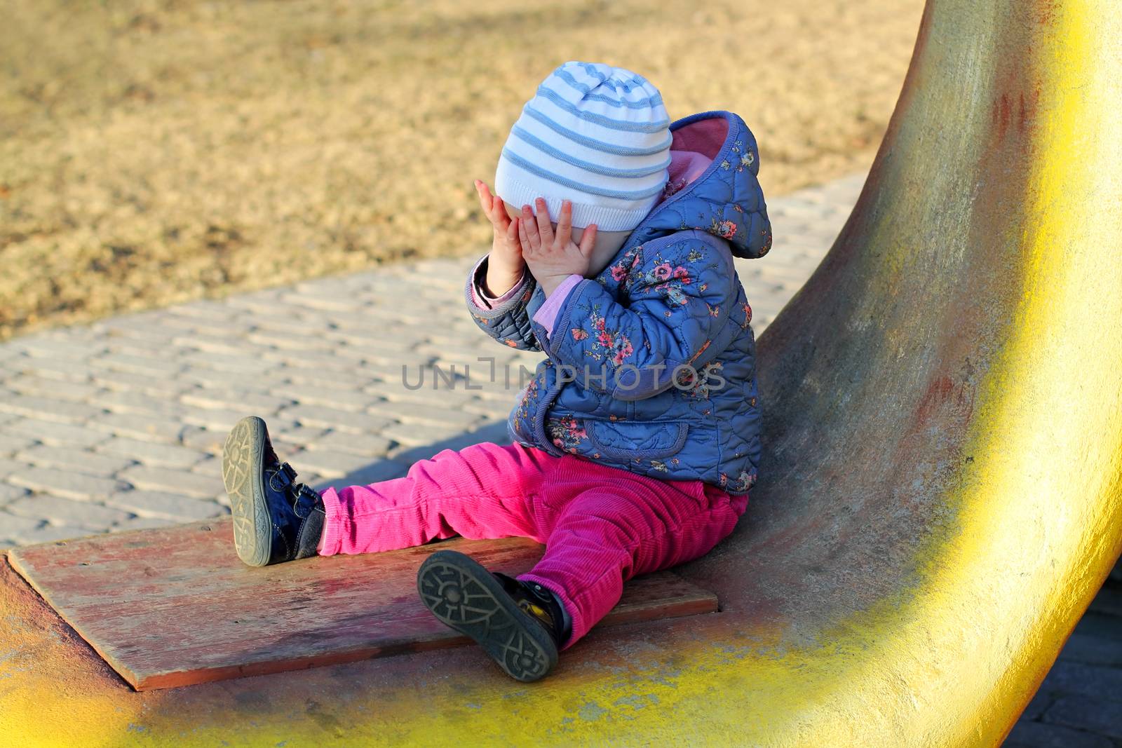 Little crying girl in park