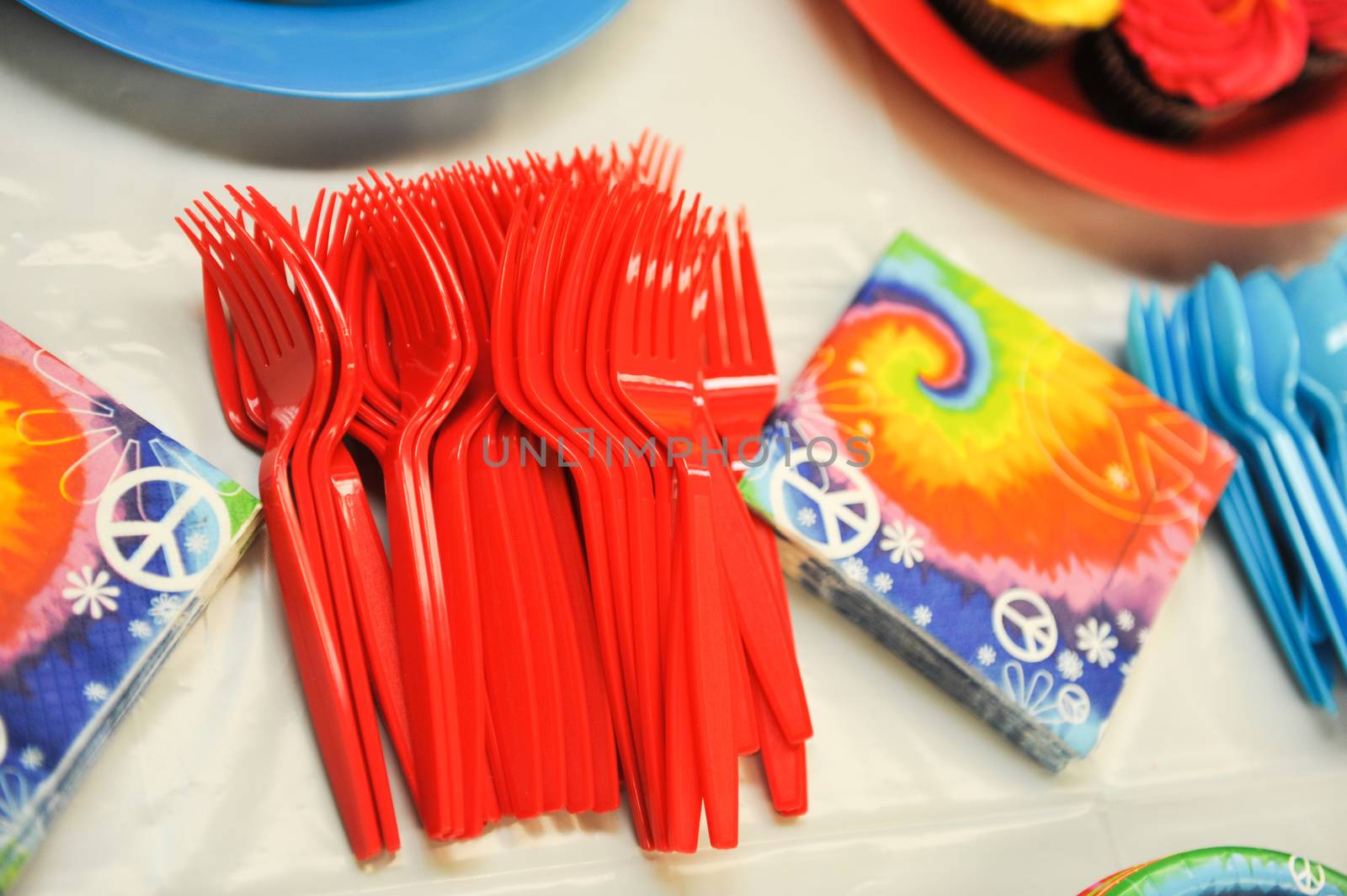 bright plastic disposable forks on table with napkin for birthday party