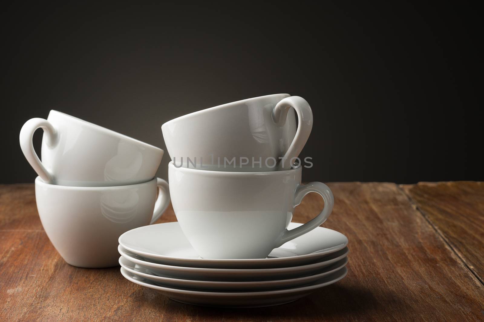Four plain white ceramic coffee cups by MOELLERTHOMSEN