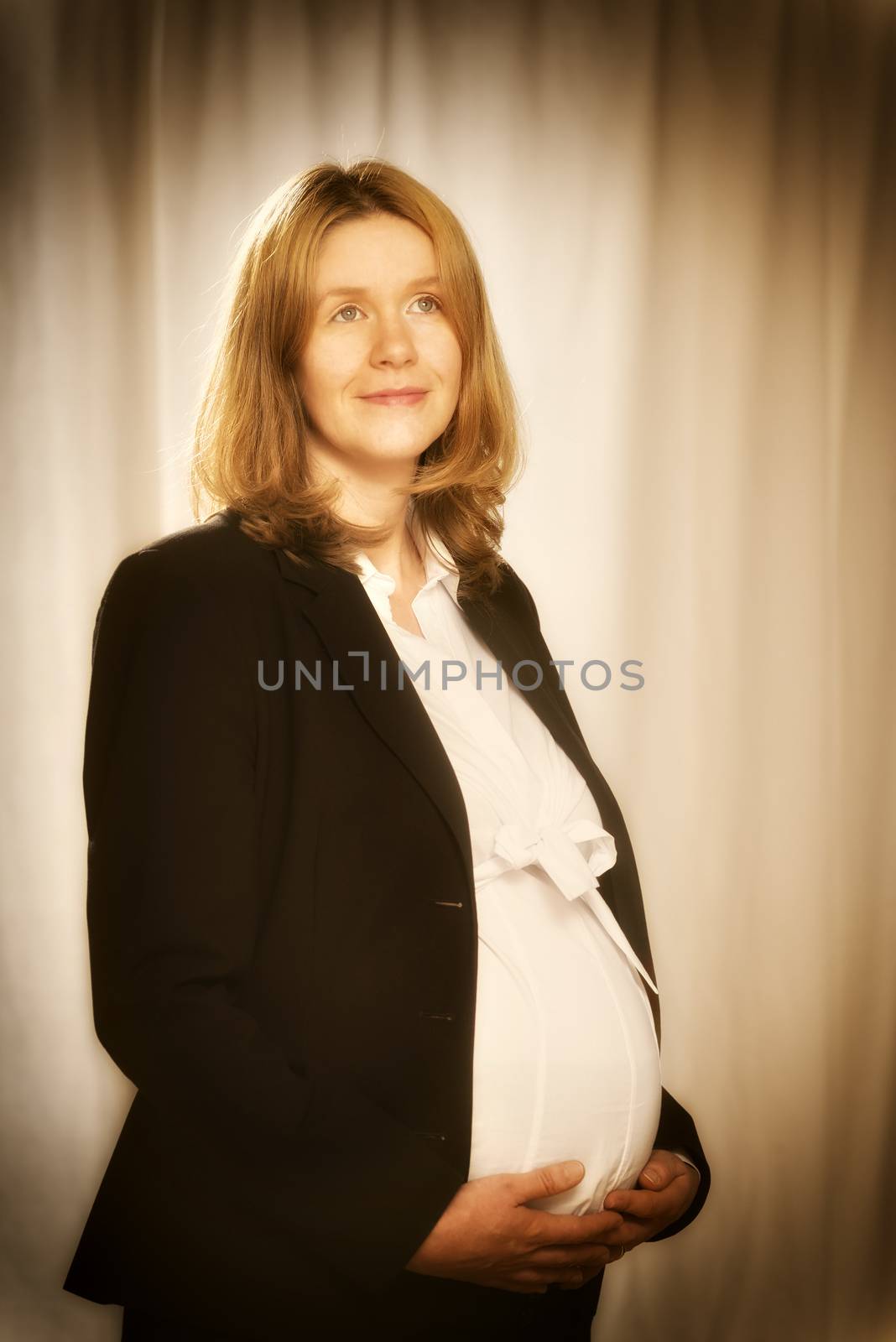Pregnant blond business woman in black business clothing