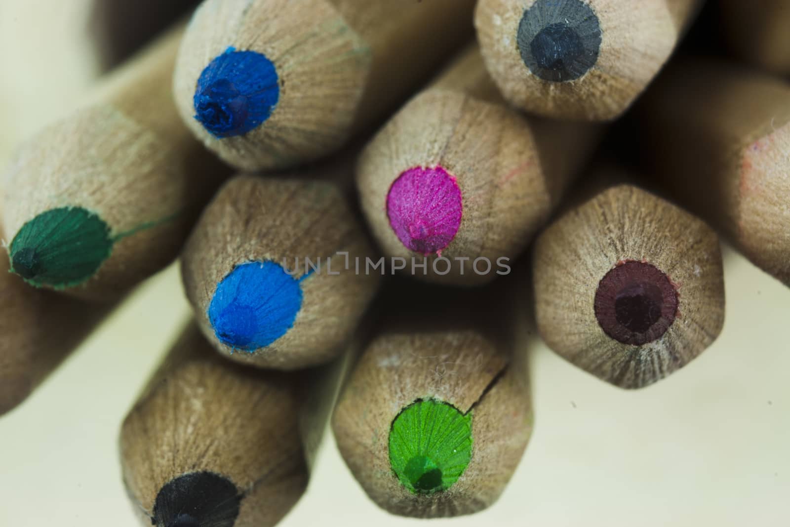 Close f of coloured pencils against a wooden background