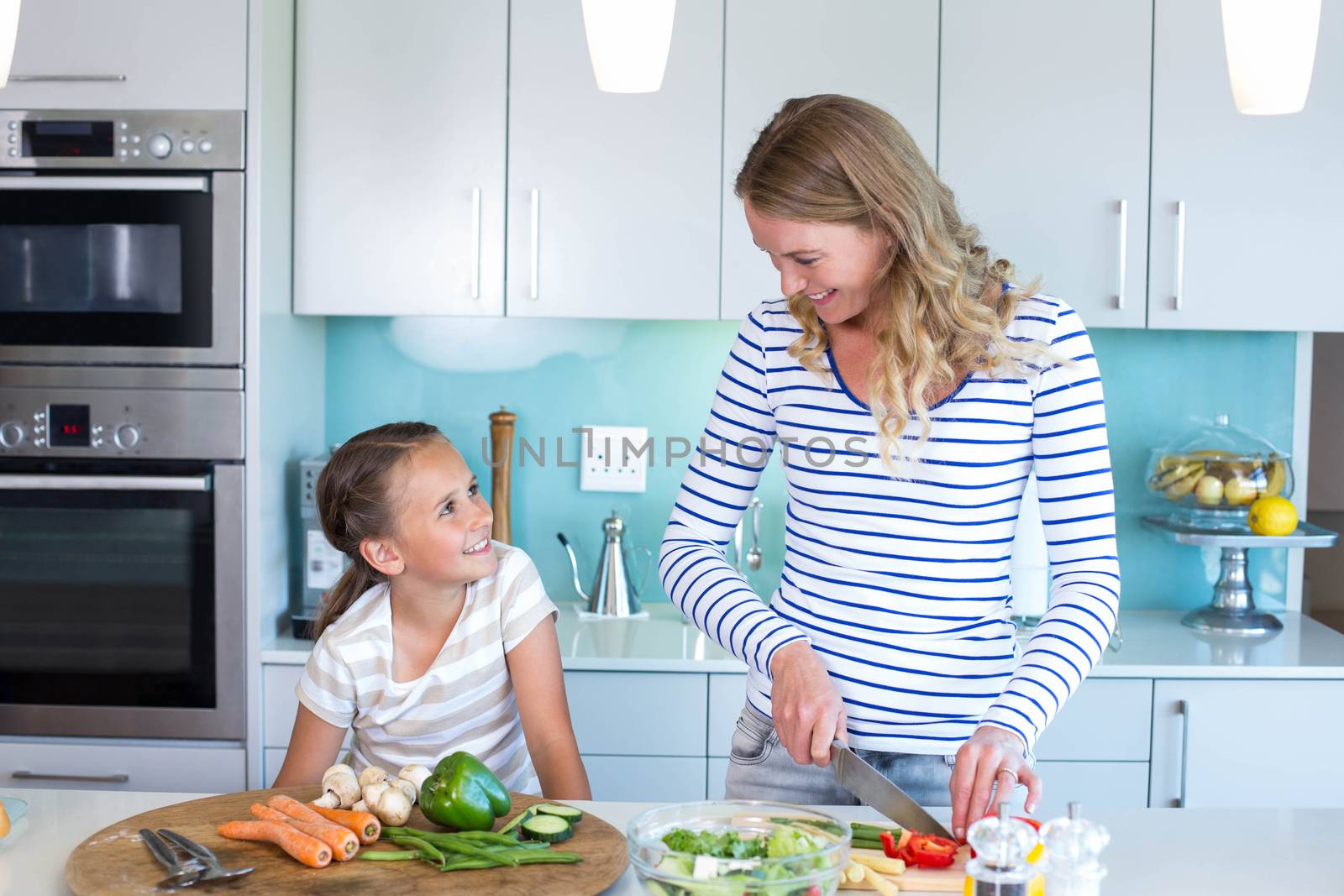 Happy family preparing lunch together at home in the kitchen